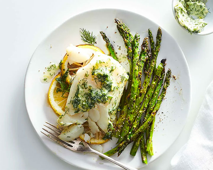 Grilled cod with lemon-dill butter, plated with asparagus